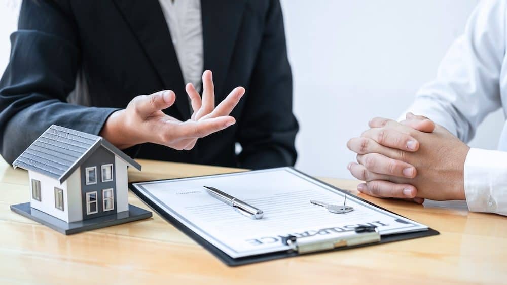 Estate agent are presenting home loan and giving house to client after discussing and signing agreement contract with approved application form, Home Insurance and Real estate investment concept.