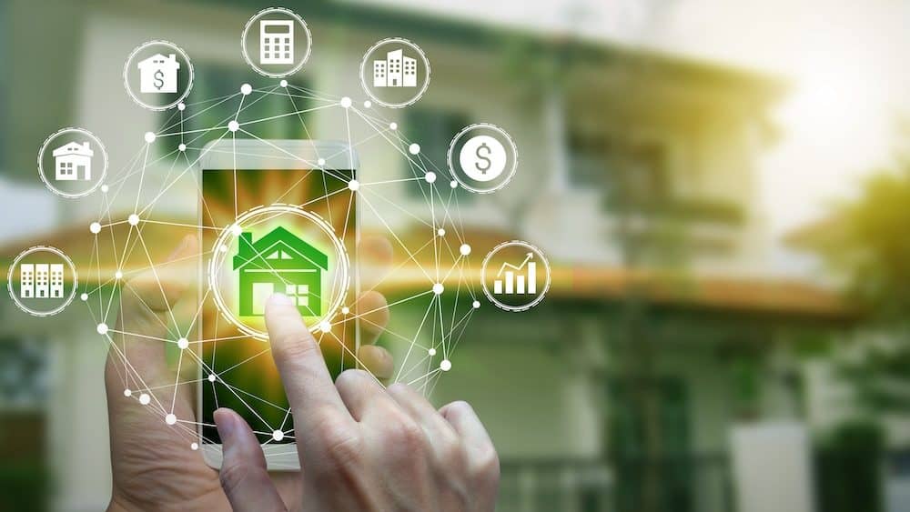 Hand use smartphone with property investment icons over the Network connection on property background, Property investment concept.