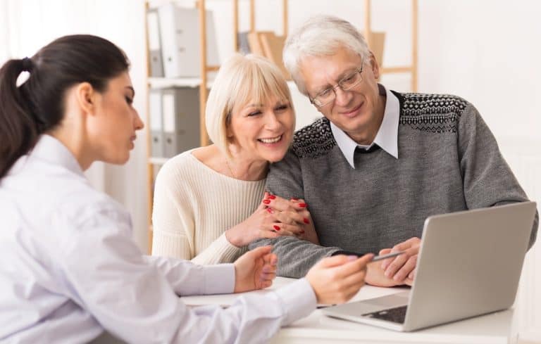 Senior couple meeting financial adviser for investment